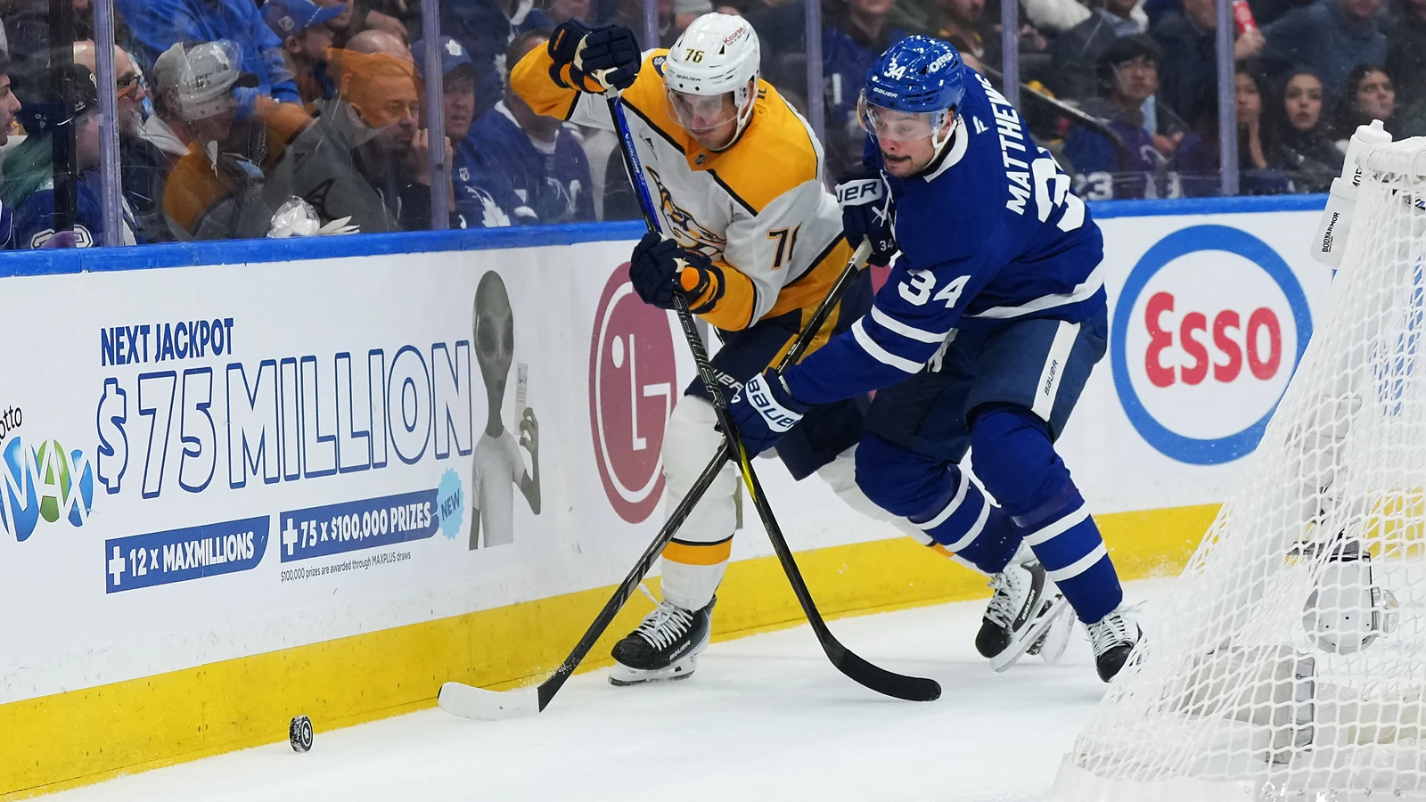 Auston Matthews battles for the puck against Nashville beside the net at Scotiabank Arena.