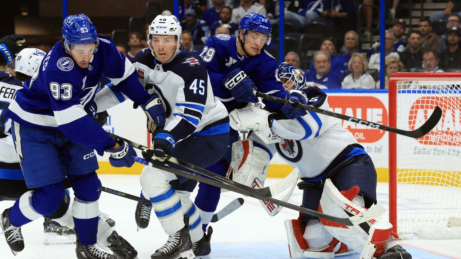 Tampa Bay Lightning forward Pontus Holmberg battles for position beside Winnipeg Jets goaltender Nico Daws during their game in Tampa.