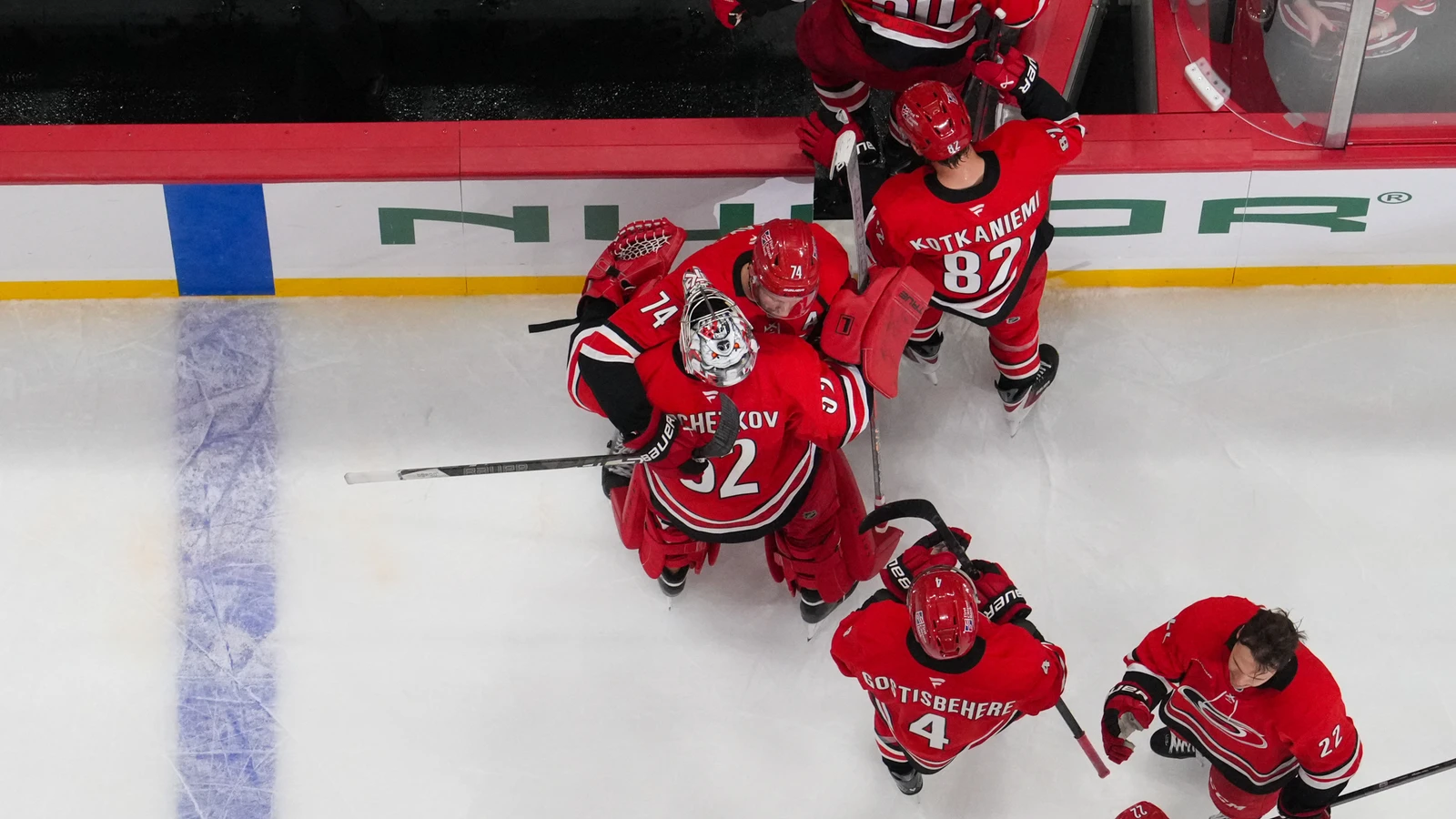 File photo: Carolina Hurricanes players gather around their goaltender after a win at Lenovo Center.