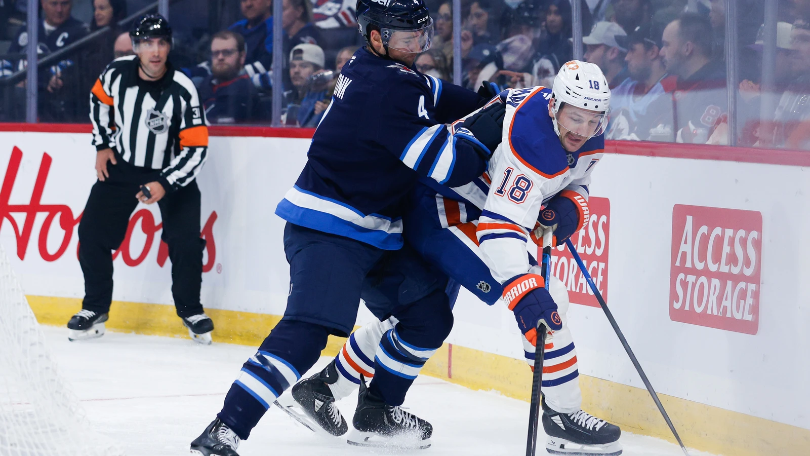 File photo: Edmonton Oilers forward Zach Hyman is checked by Winnipeg Jets defenceman Neal Pionk during a preseason game in Winnipeg on Sept. 22, 2026.