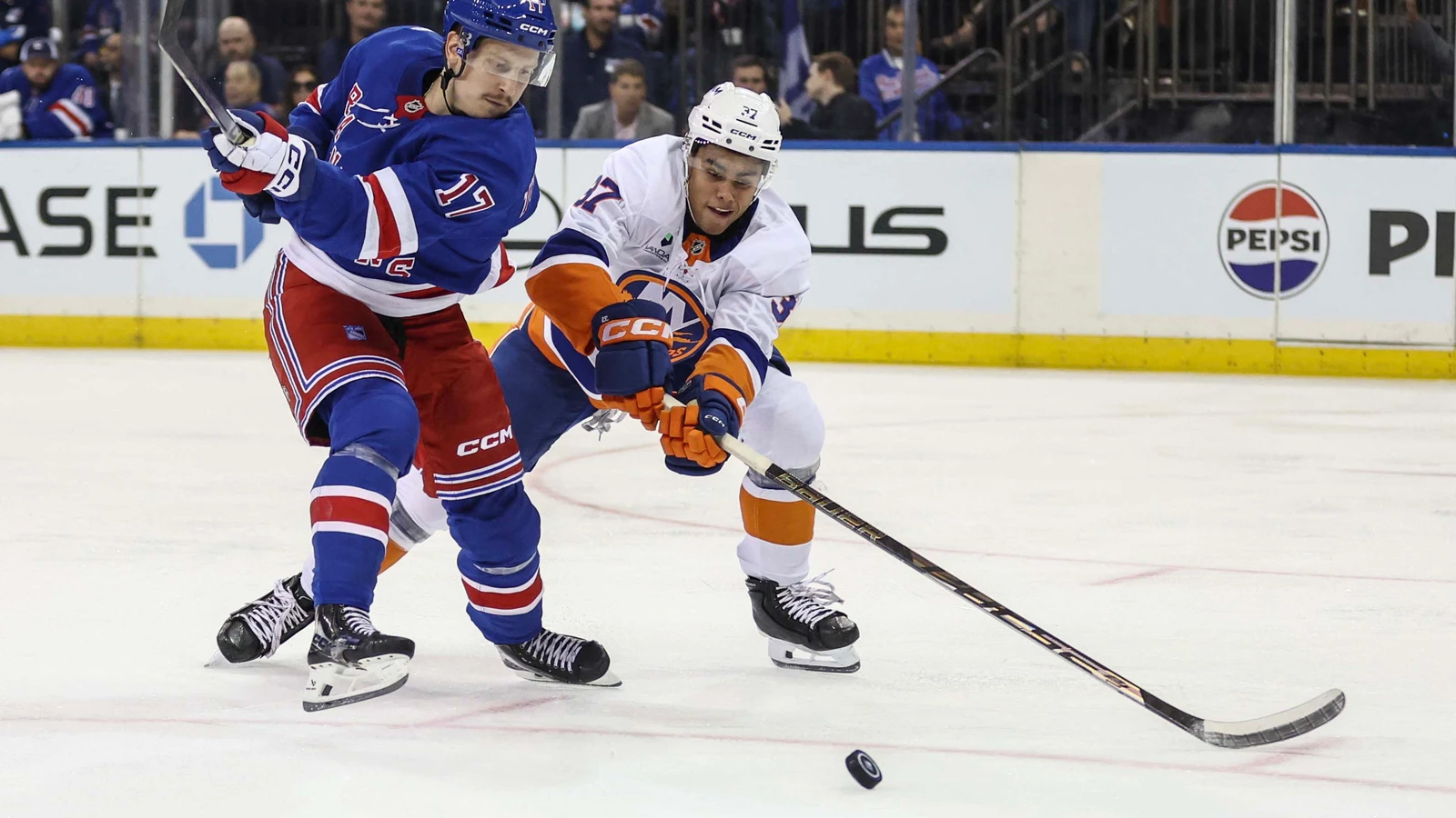 File photo: New York Islanders defenceman Kashawn Aitcheson, No. 37, battles New York Rangers forward Eeli Tolvanen for the puck in a preseason game at Madison Square Garden on September 22, 2026.