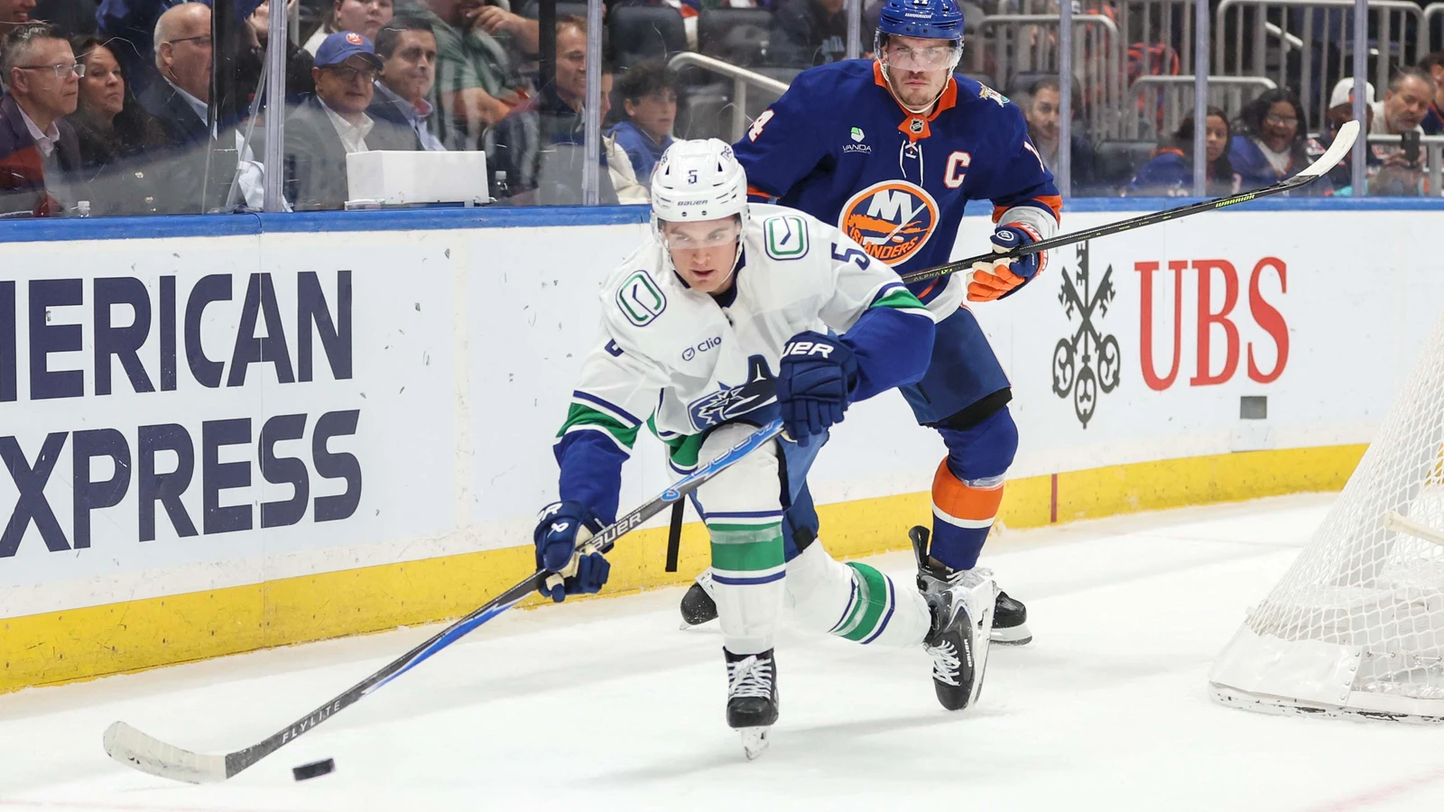 File photo: Bo Horvat pursues Vancouver Canucks defenceman Tom Willander along the boards at UBS Arena.