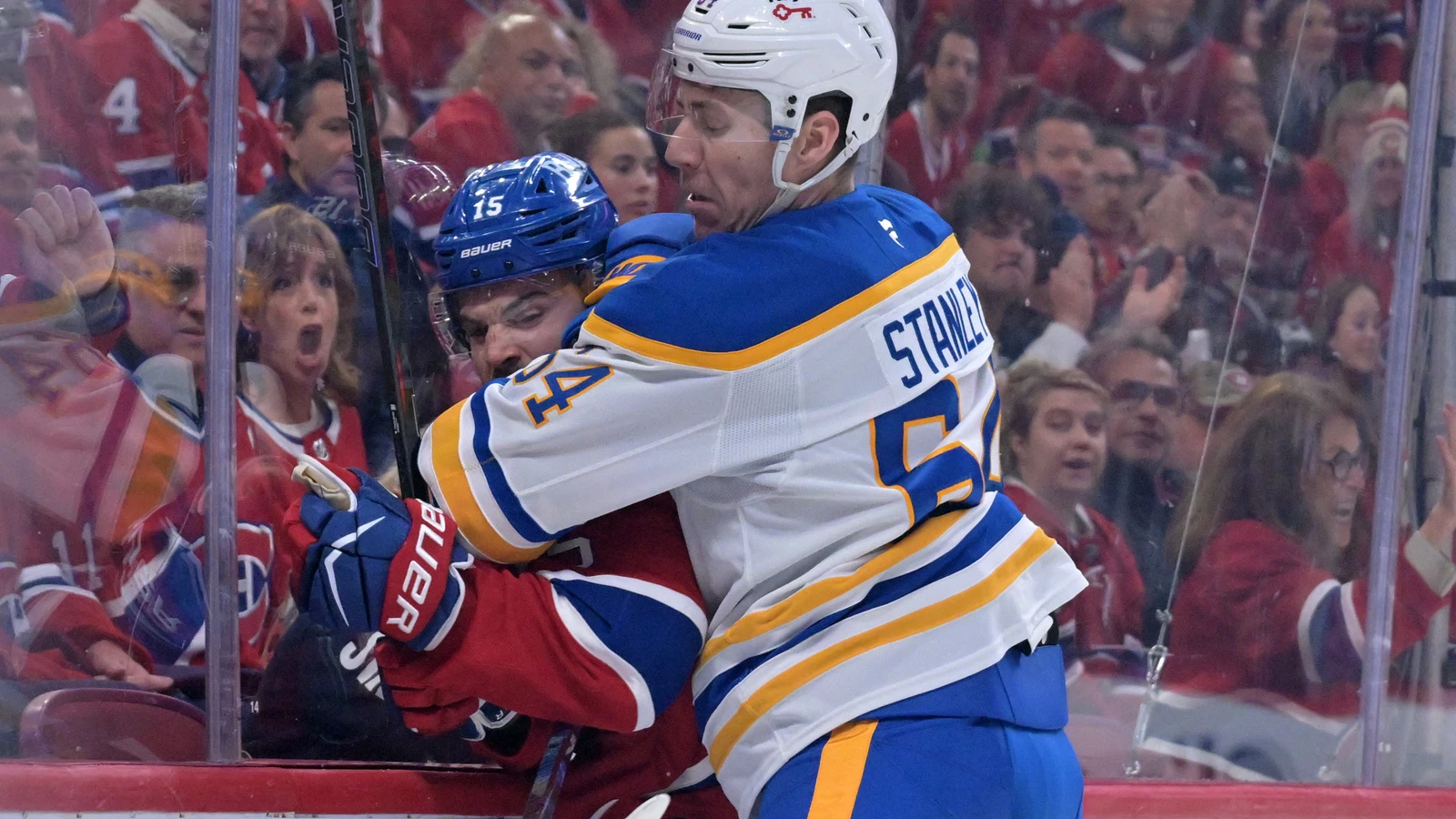 File photo: Logan Stanley, then with the Buffalo Sabres, checks Montreal Canadiens forward Alex Newhook during a playoff game at the Bell Centre on May 10, 2026.