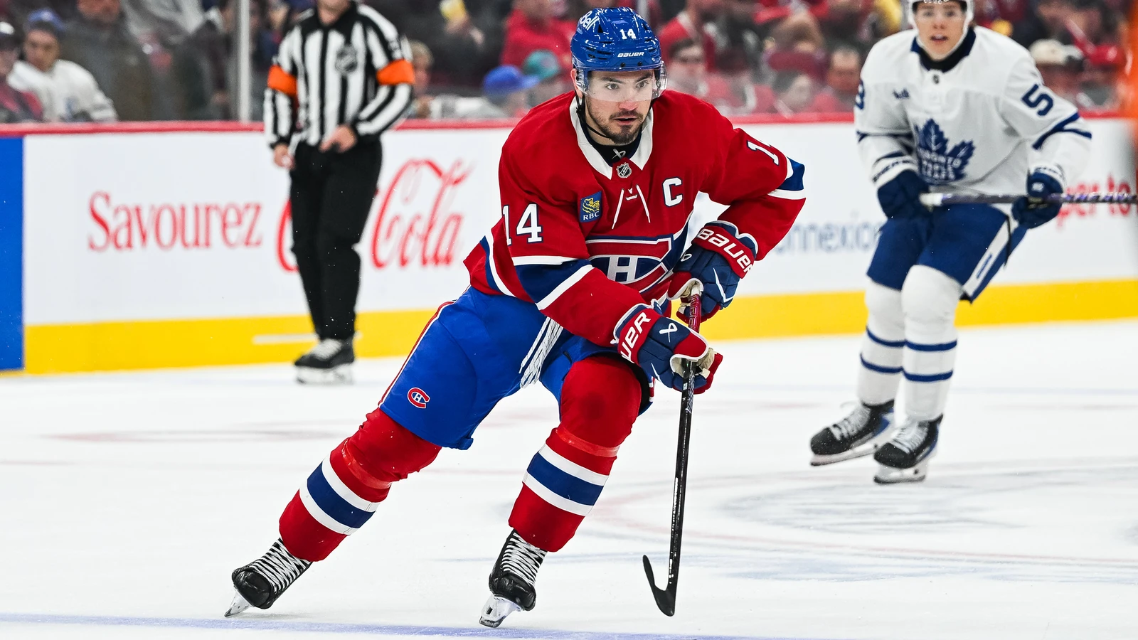 File photo: Nick Suzuki plays the puck in the Canadiens’ regular home uniform against the Toronto Maple Leafs at Bell Centre.