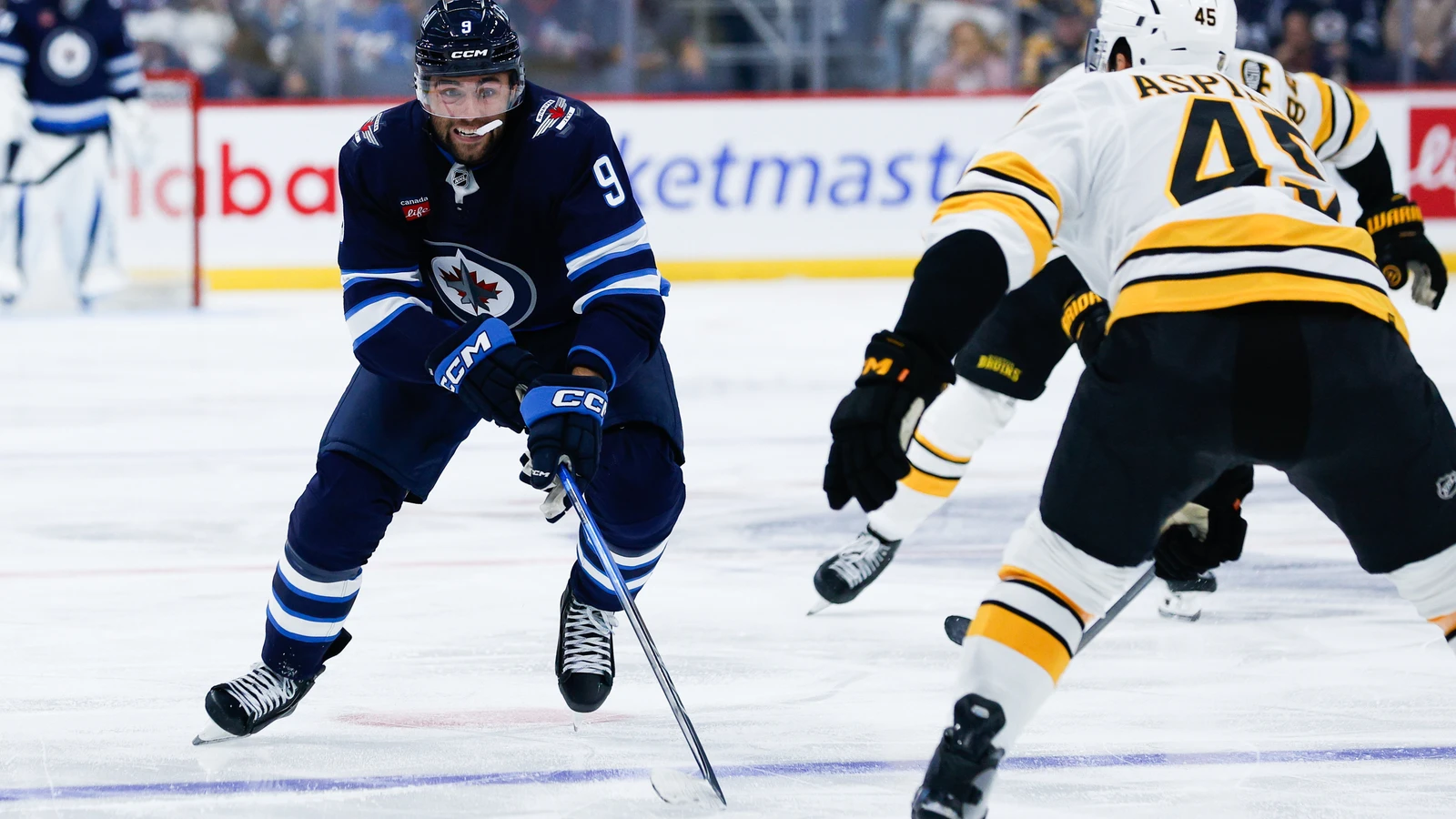File photo: Winnipeg Jets forward Alex Iafallo skates towards Boston Bruins defenceman Jonathan Aspirot at Canada Life Centre on October 2, 2026.