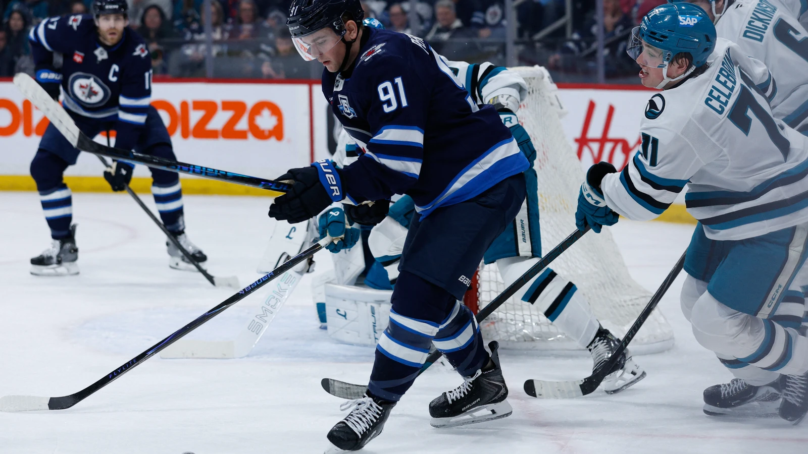 Cole Perfetti shields the puck for Winnipeg against San Jose on April 16, 2026. File photo.
