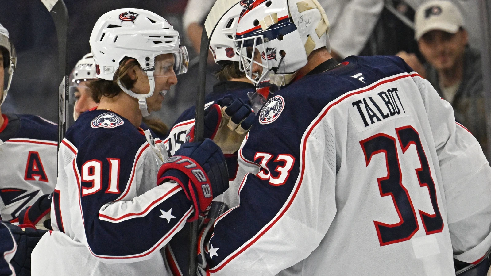 Columbus Blue Jackets forward Kent Johnson celebrates with goaltender Cam Talbot after an overtime win over the Philadelphia Flyers.