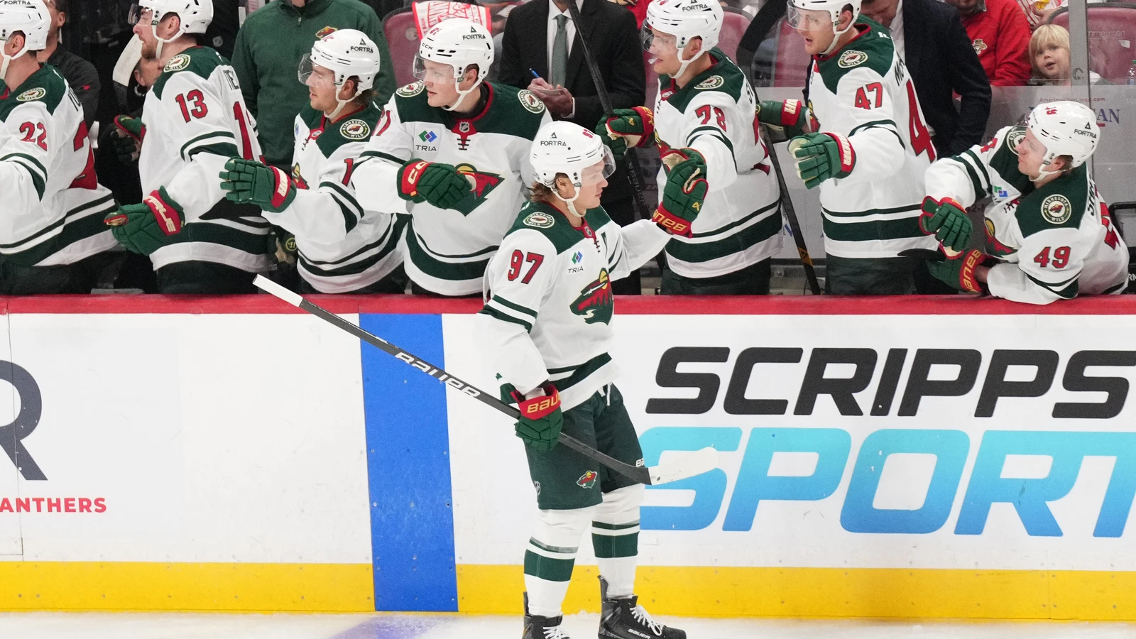 Kirill Kaprizov celebrates a goal with Minnesota Wild teammates at the bench in Florida.