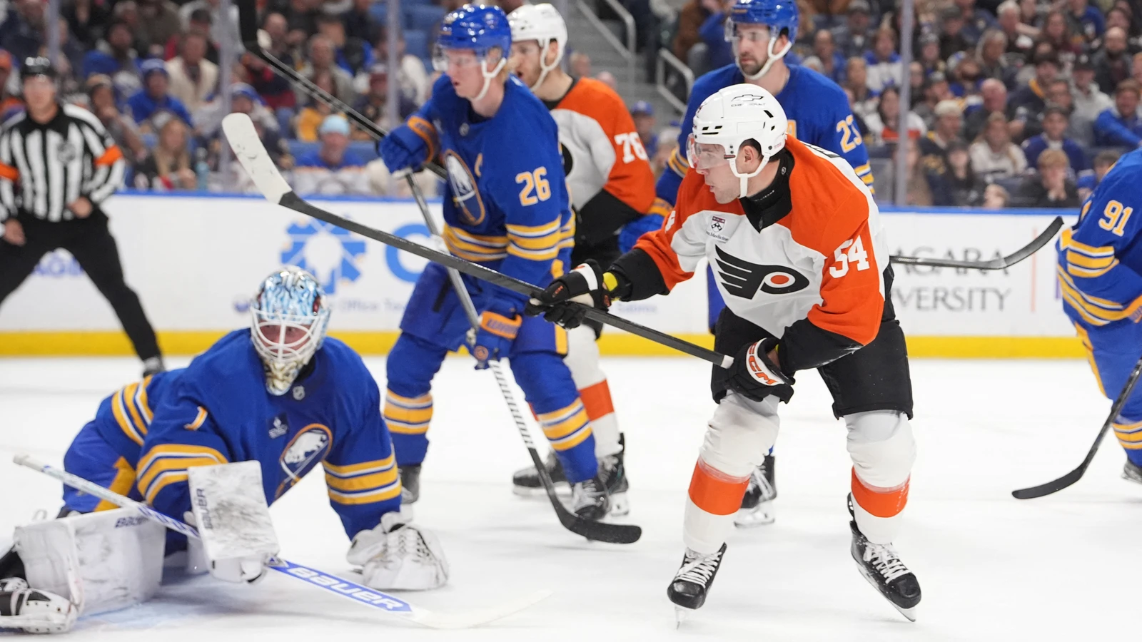 Philadelphia Flyers forward Cole Knuble plays the puck in front of Buffalo Sabres goalie Ukko-Pekka Luukkonen at KeyBank Center.