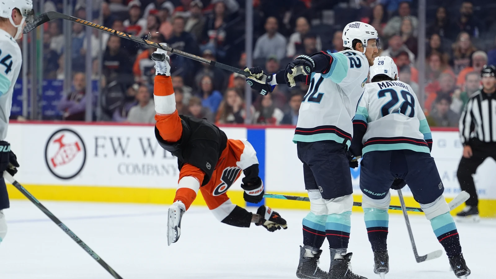 File photo: Kraken defenceman Brandon Montour upends Flyers centre Trevor Zegras in Philadelphia on Oct. 13.