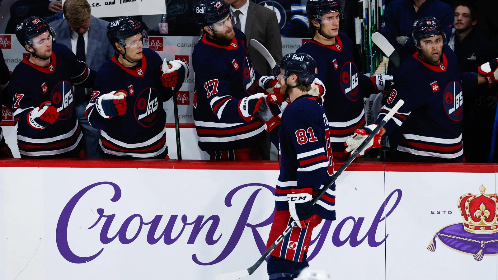 Kyle Connor (81) exchanges glove taps with Winnipeg Jets teammates after scoring against the Colorado Avalanche at Canada Life Centre.