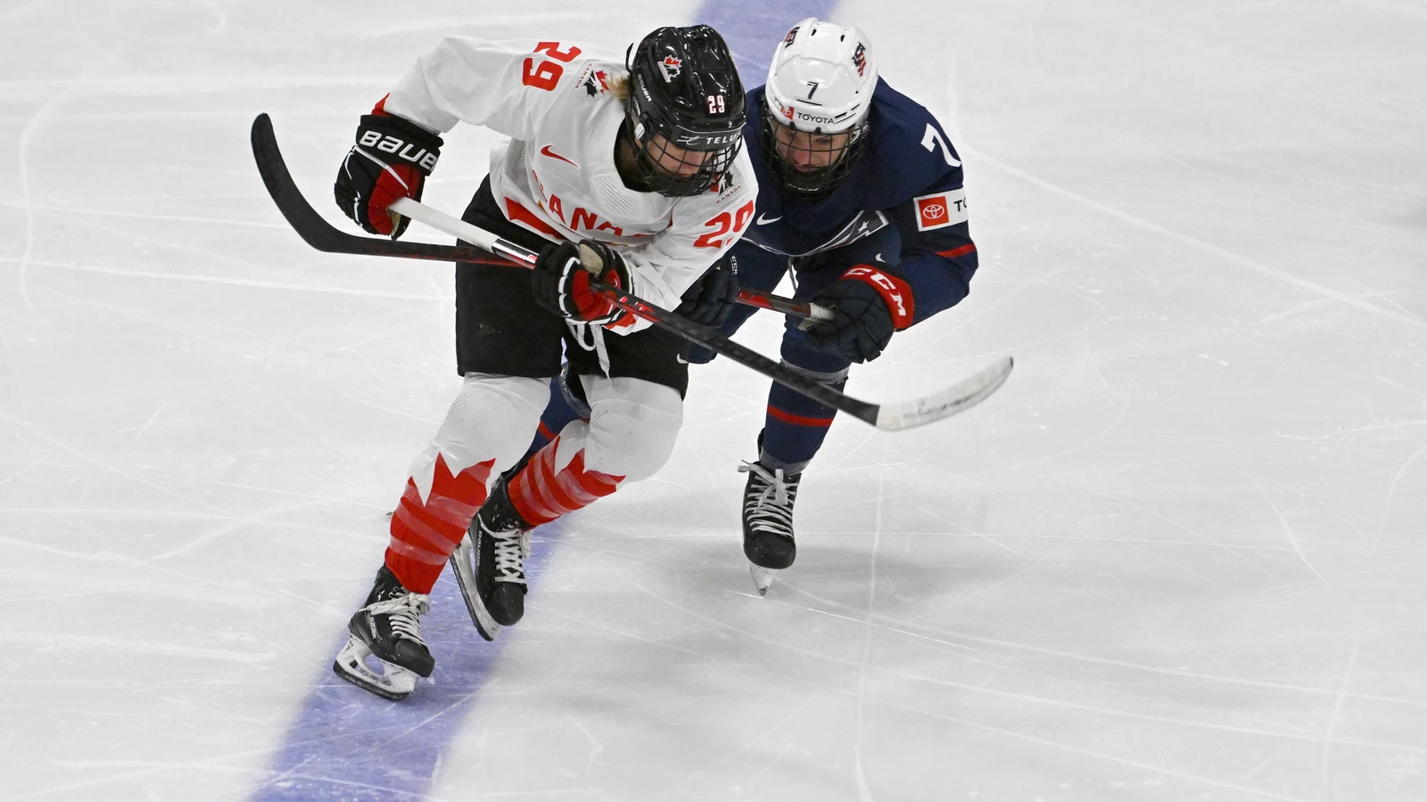 United States forward Lacey Eden pursues the puck with Canada forward Marie-Philip Poulin during the IIHF Women's World Championship on April 16, 2023. File photo.