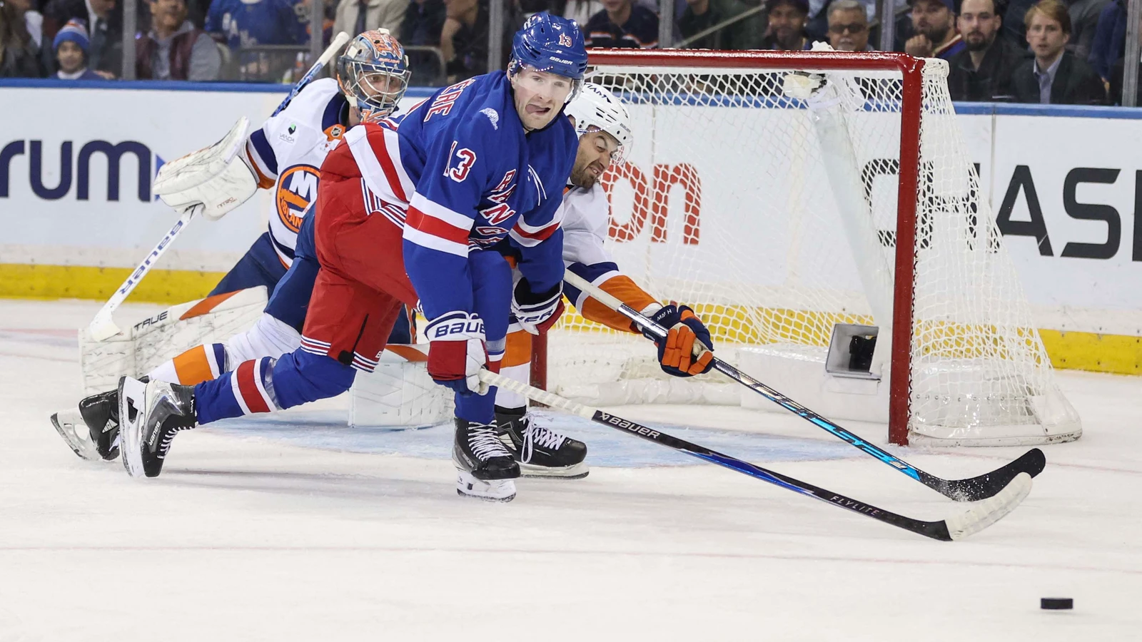 New York Rangers winger Alexis Lafrenière controls the puck near the Islanders net at Madison Square Garden.