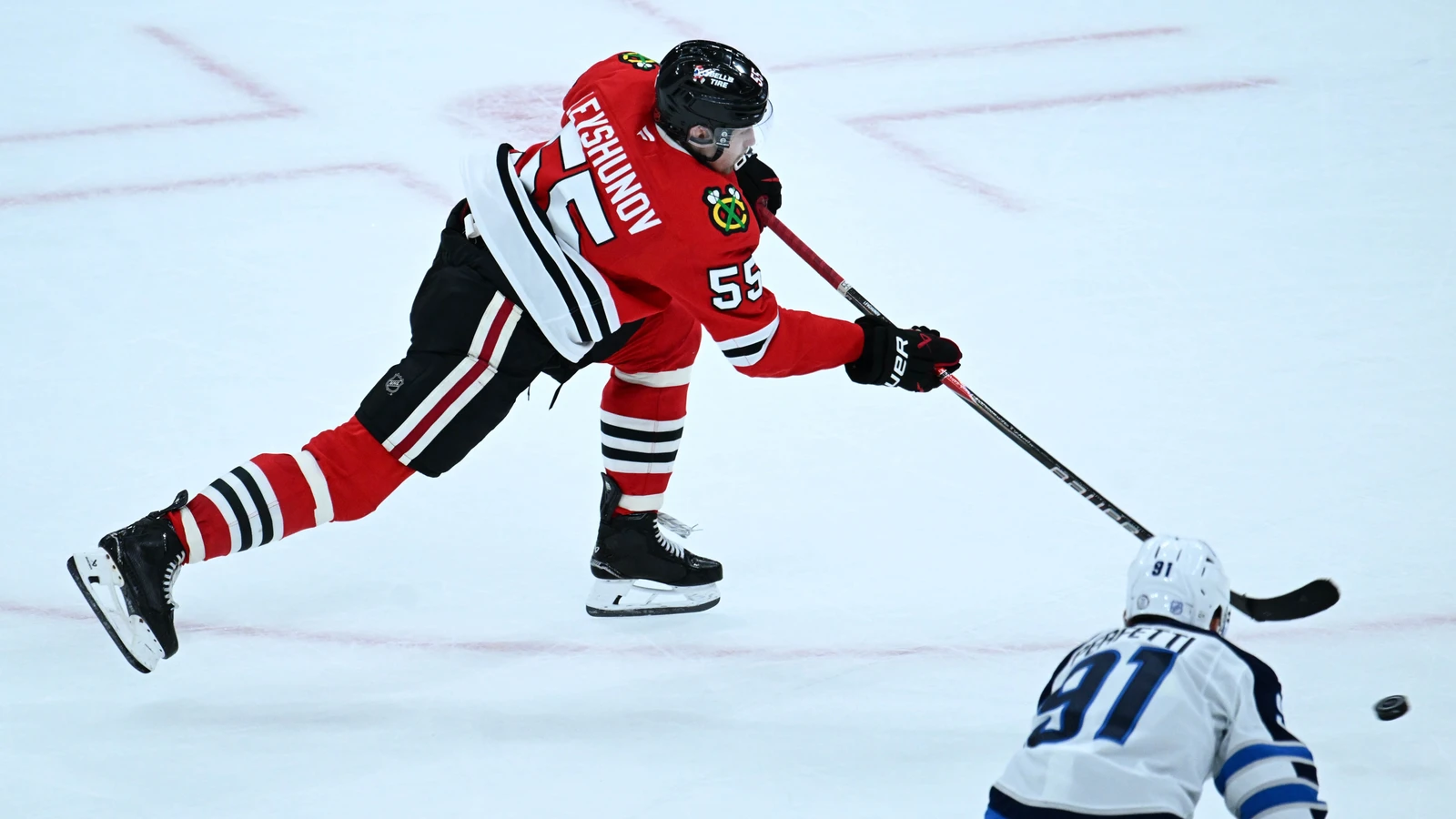 Artyom Levshunov shoots the puck for the Chicago Blackhawks during overtime against the Winnipeg Jets at United Center.