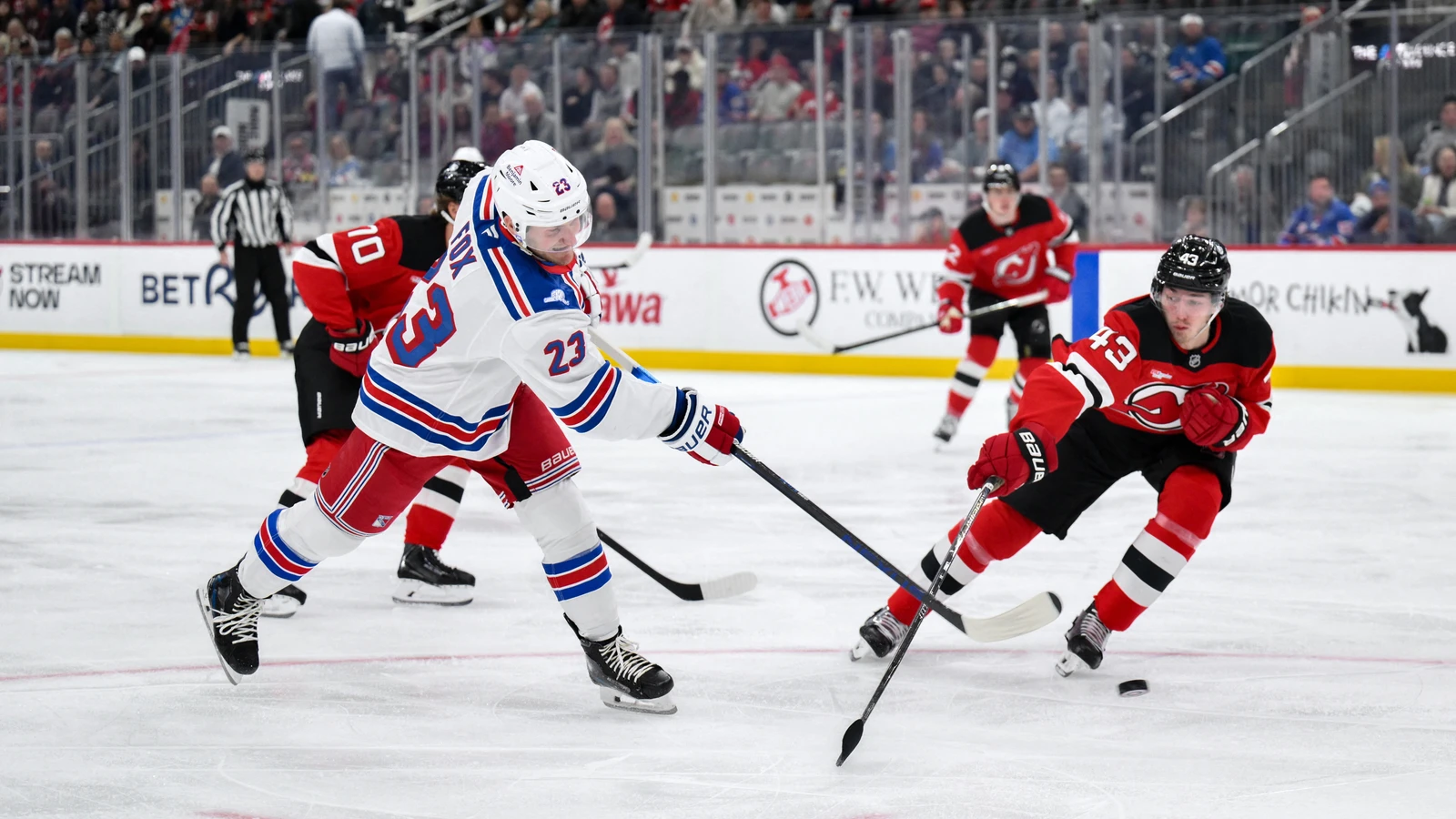 New Jersey Devils defenceman Luke Hughes defends against a New York Rangers shot at Prudential Center.