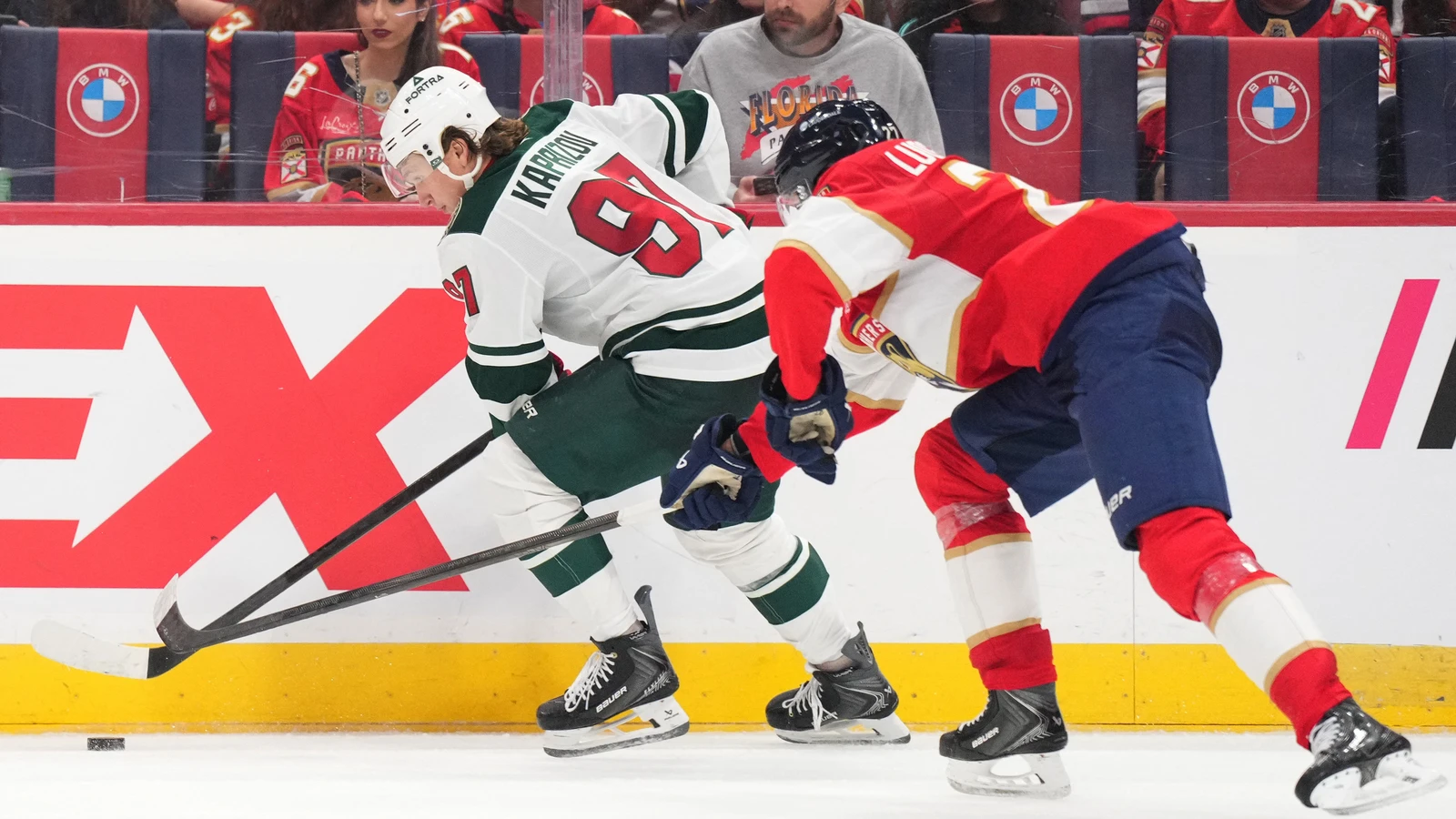 Florida Panthers centre Eetu Luostarinen battles Minnesota Wild forward Kirill Kaprizov for the puck.