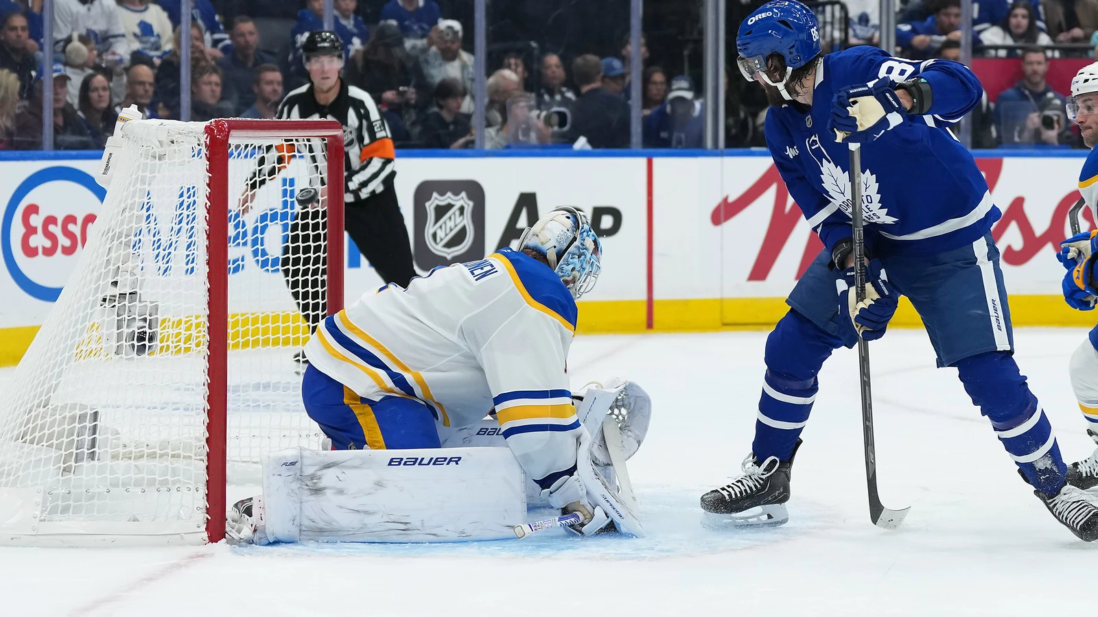 Toronto Maple Leafs winger Kirill Marchenko shoots between his legs against Buffalo Sabres goaltender Ukko-Pekka Luukkonen in Toronto.