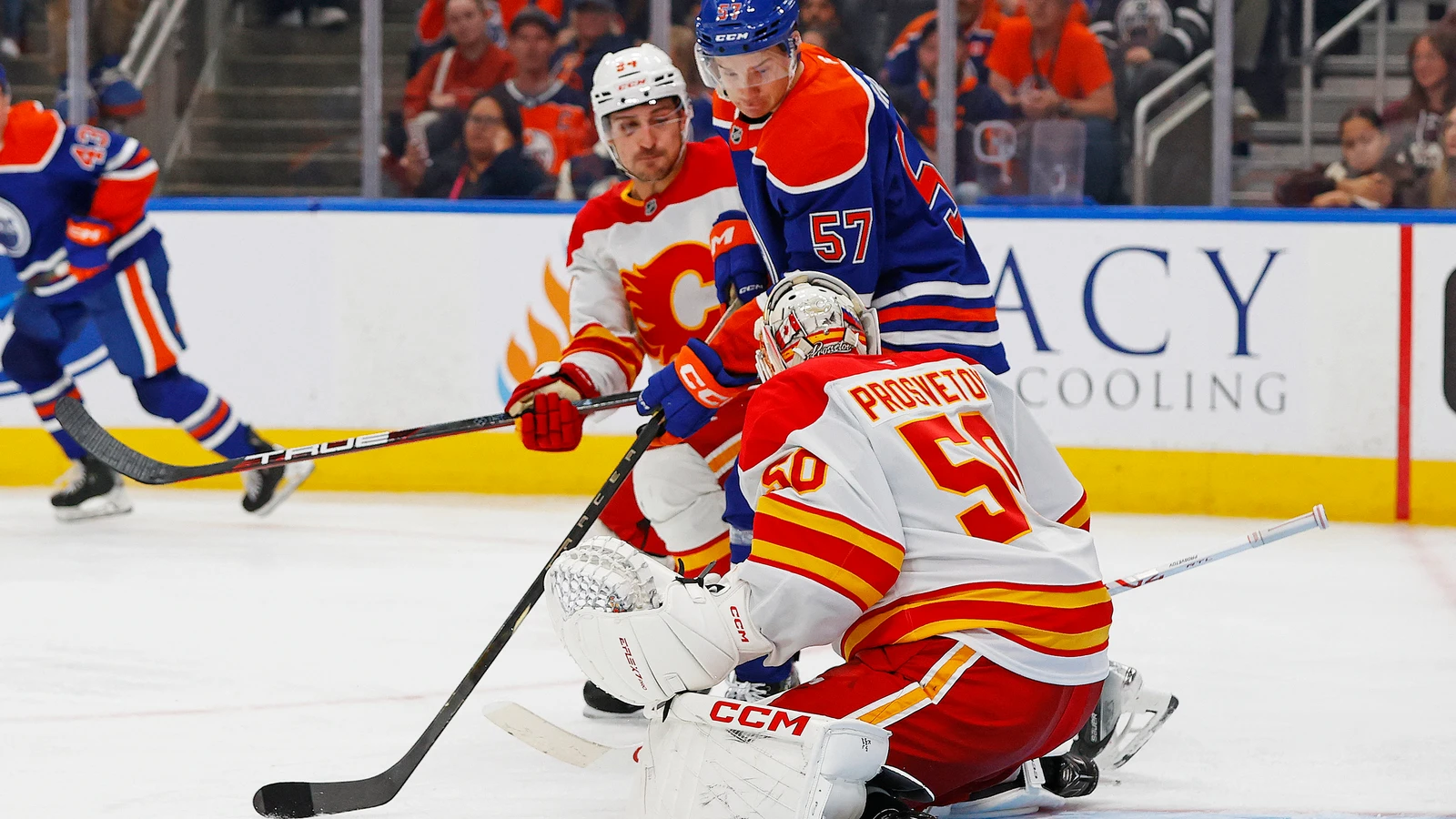 File photo: Edmonton Oilers forward Viljami Marjala (57) looks for a loose puck in front of Calgary Flames goalie Ivan Prosvetov during a Sept. 21, 2025 preseason game in Edmonton.