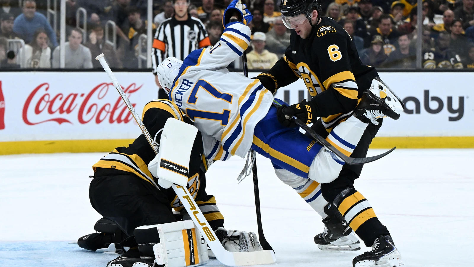 Mason Lohrei checks Jason Zucker for Boston on April 23, 2026. File photo.