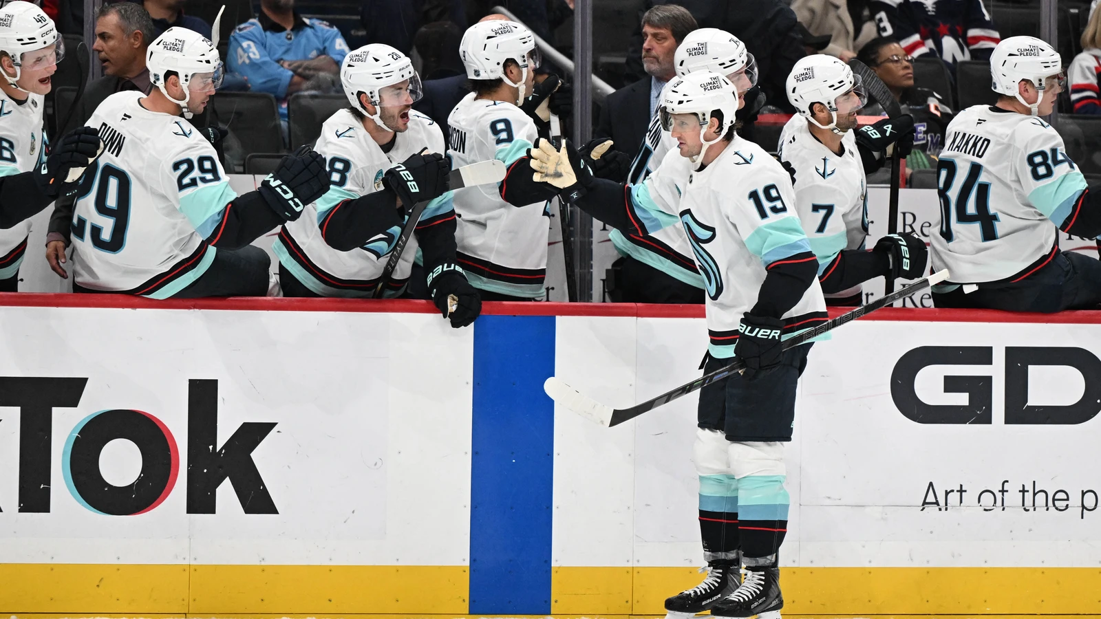 Seattle Kraken left wing Jared McCann celebrates his third-period goal with teammates at Capital One Arena.