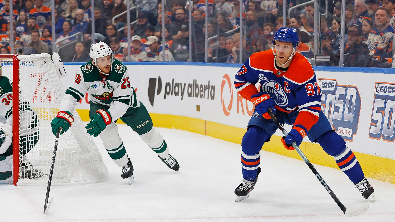 Connor McDavid controls the puck as Minnesota Wild defenceman Jonas Brodin defends.