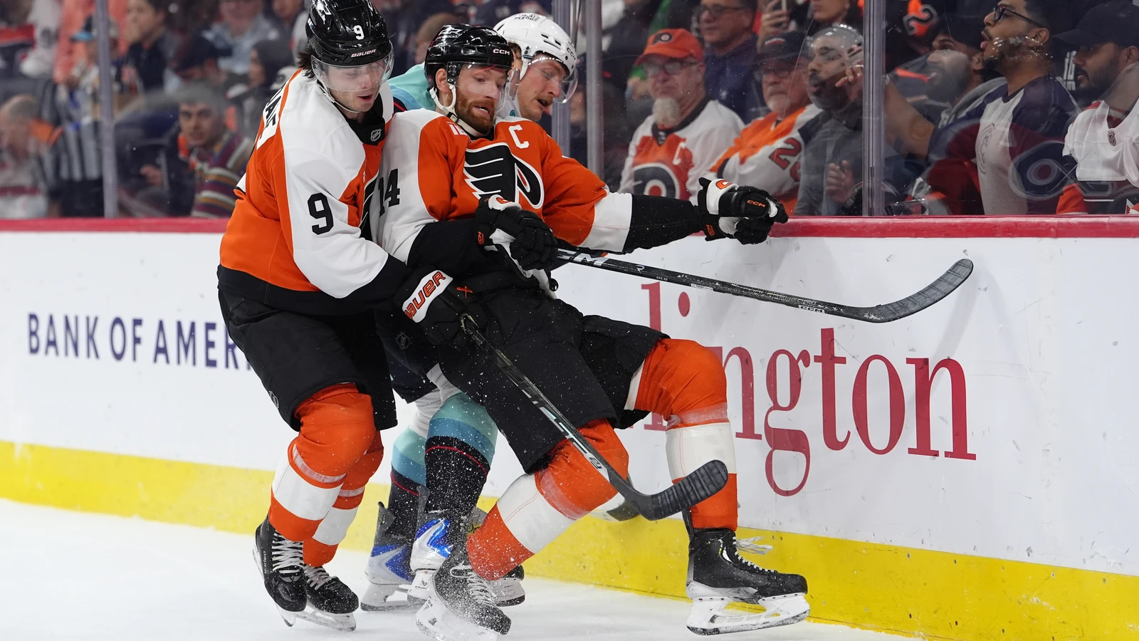 Seattle Kraken forward Bobby McMann collides with two Philadelphia Flyers players during the second period at Xfinity Mobile Arena.