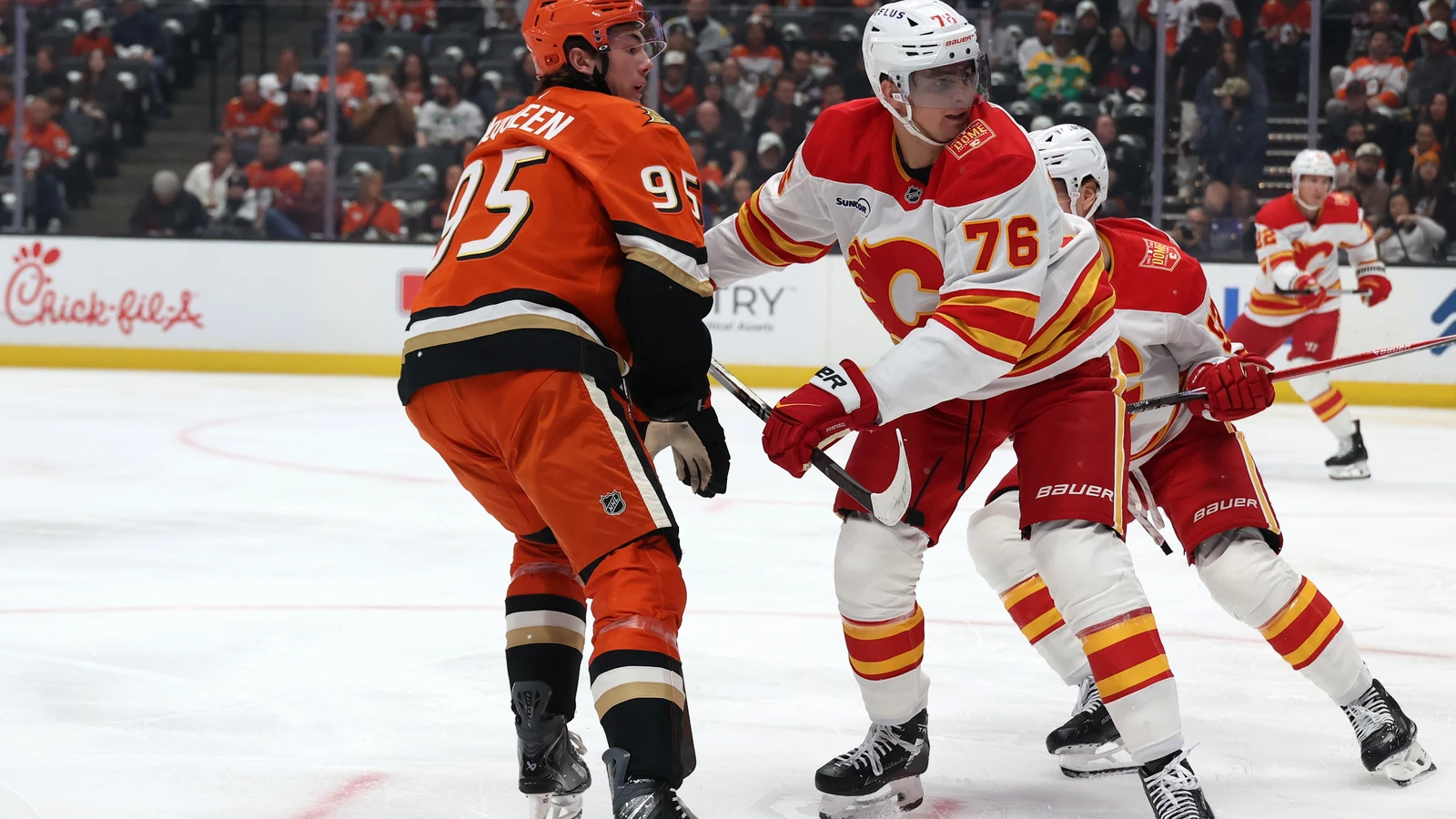 Anaheim Ducks centre Roger McQueen skates beside Calgary Flames centre Martin Pospisil during his NHL debut at Honda Center.
