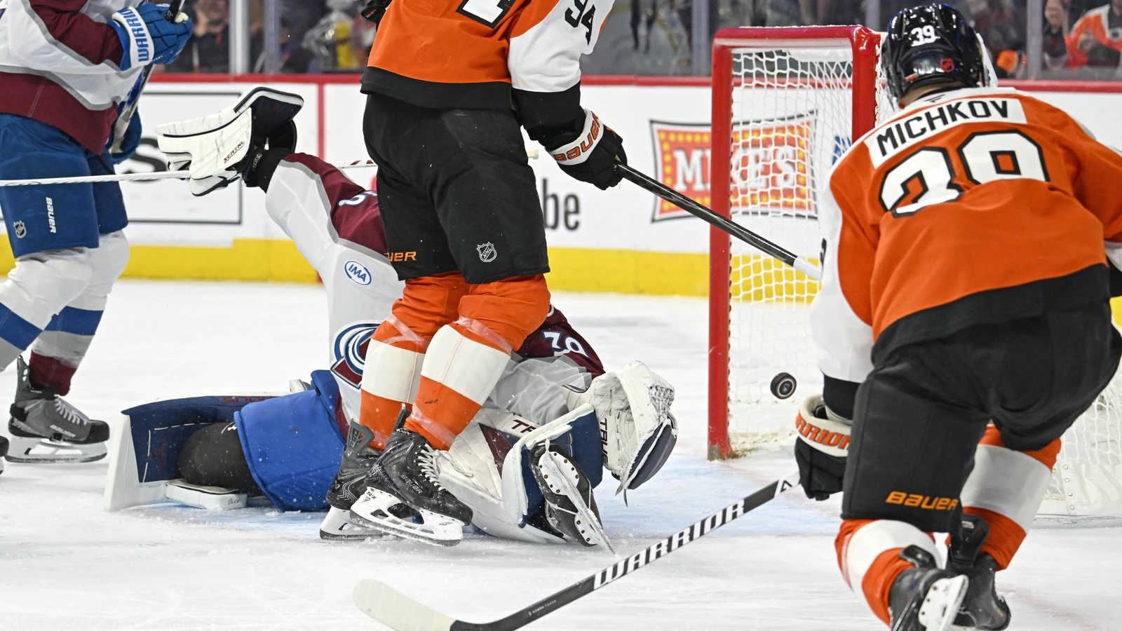 Matvei Michkov scores as Porter Martone stands in front of Colorado goaltender Mackenzie Blackwood in Philadelphia.