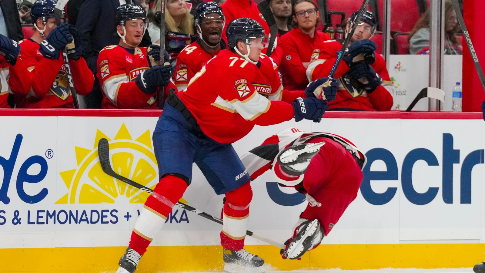 File photo: Florida Panthers defenceman Niko Mikkola checks a Carolina Hurricanes player along the boards.