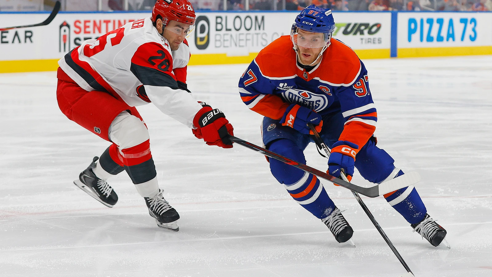 File photo: Edmonton Oilers captain Connor McDavid carries the puck past Carolina Hurricanes defenceman Sean Walker at Rogers Place.