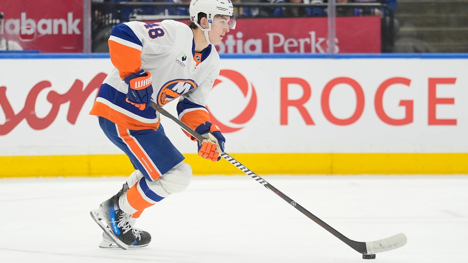 File photo: New York Islanders defenceman Matthew Schaefer carries the puck against the Toronto Maple Leafs.