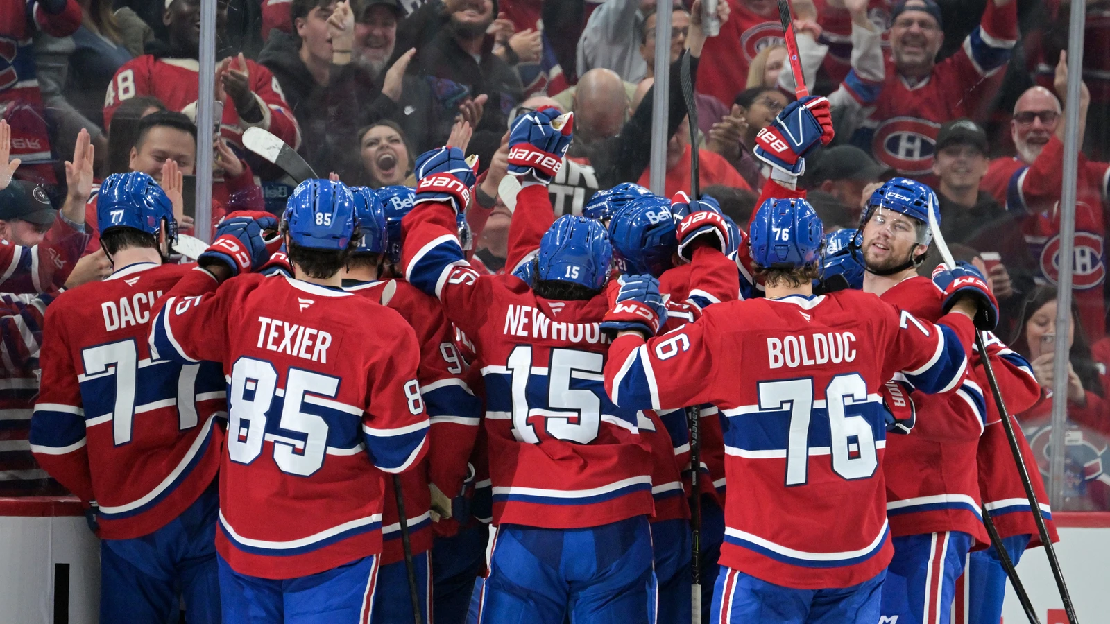 File photo: Montreal Canadiens players celebrate together along the boards at the Bell Centre.