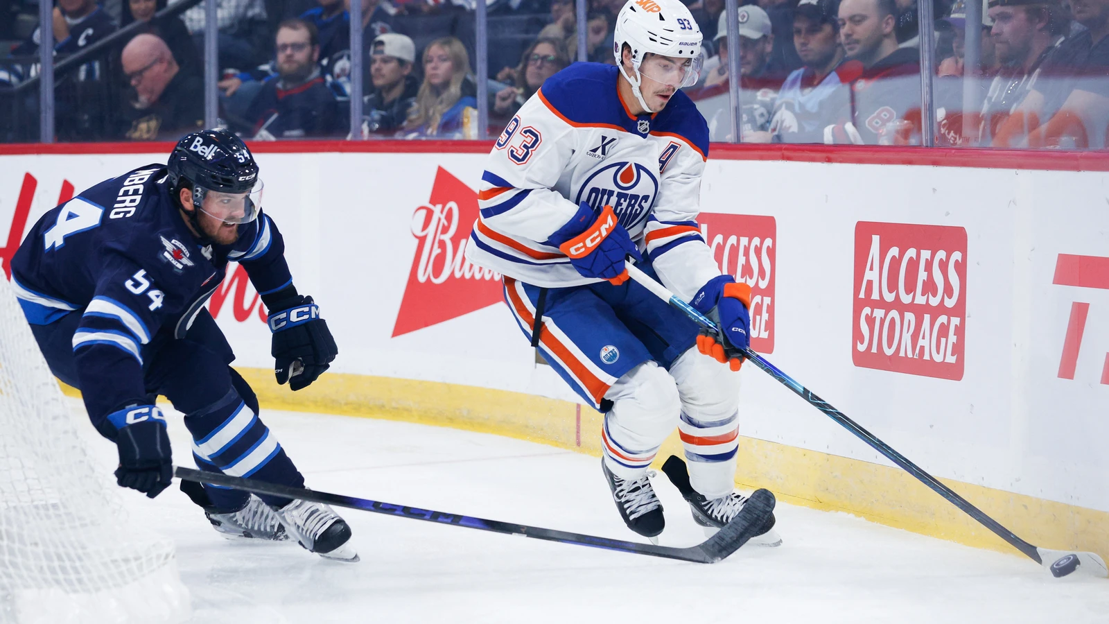 File photo: Edmonton Oilers forward Ryan Nugent-Hopkins skates with the puck as Winnipeg Jets defenceman Dylan Samberg pursues him.