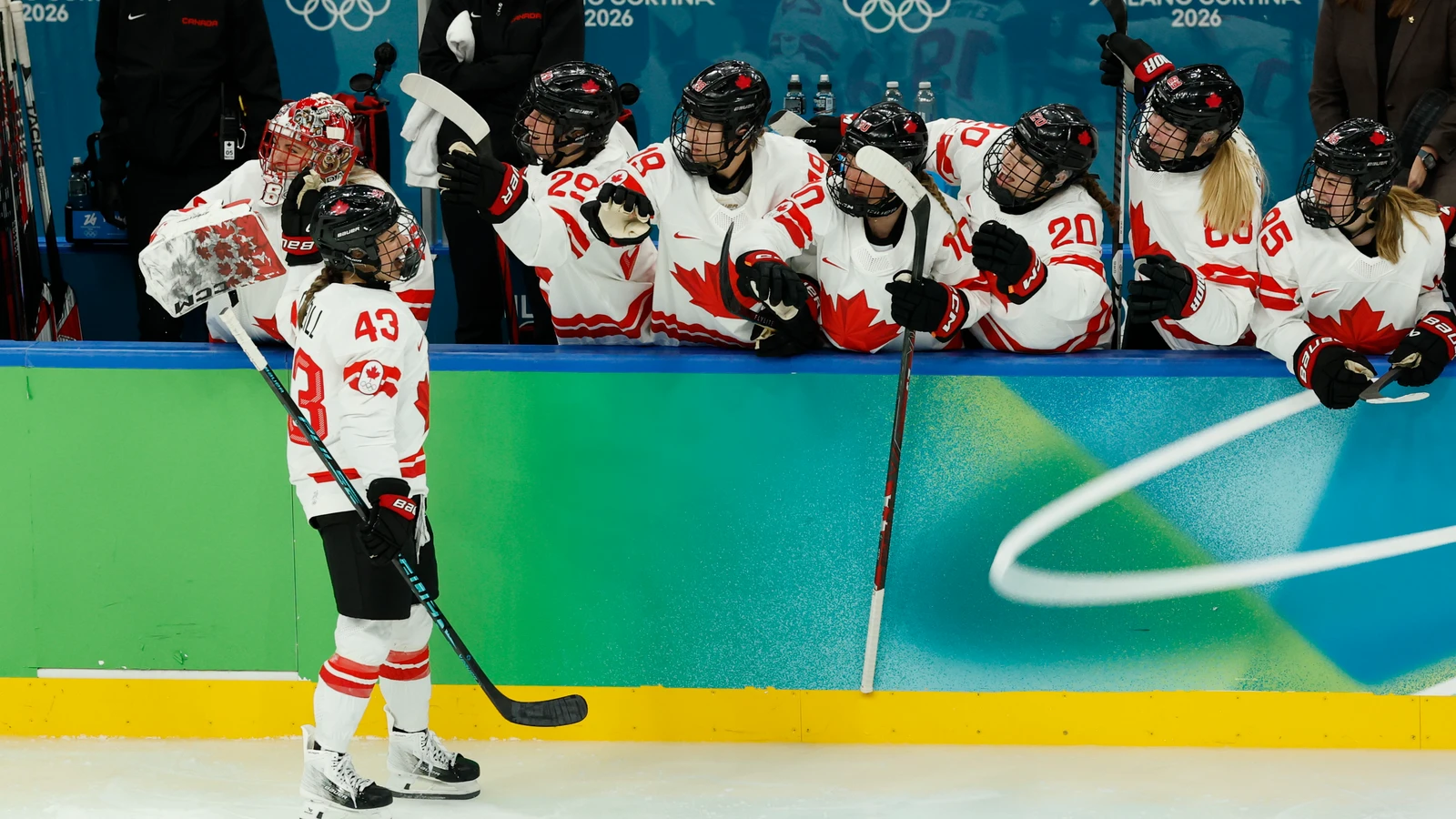 Kristin O'Neill celebrates with Canada's bench after scoring against the United States in the 2026 Olympic gold medal game.