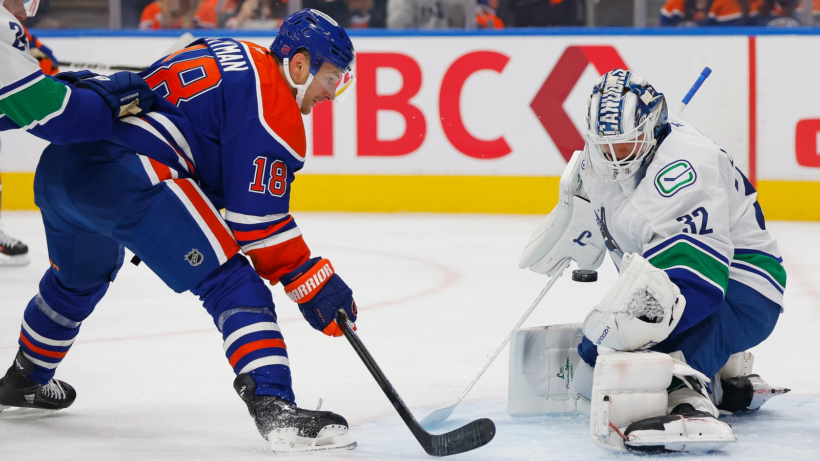 File photo: Edmonton Oilers forward Zach Hyman plays the puck in front of Vancouver Canucks goaltender Kevin Lankinen at Rogers Place.