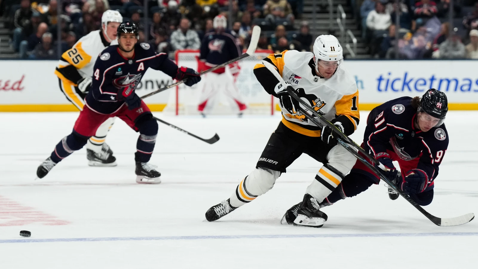 File photo: Pittsburgh Penguins centre Filip Hallander checks Columbus Blue Jackets forward Kent Johnson as they chase the puck.