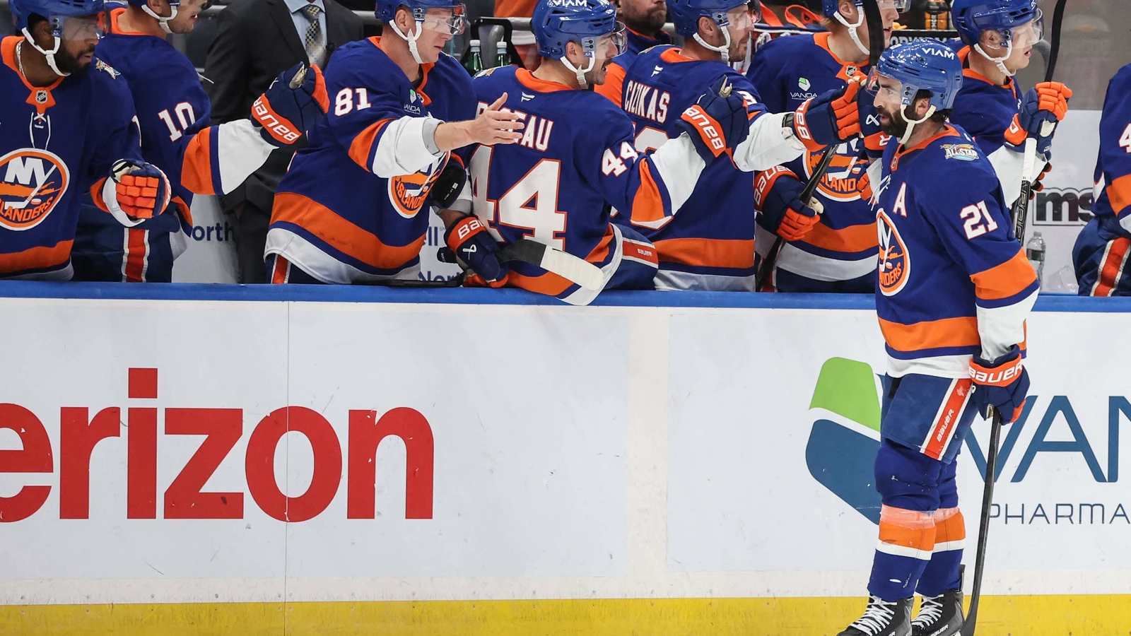 Kyle Palmieri celebrates a goal with teammates at the Islanders bench against the Vancouver Canucks.