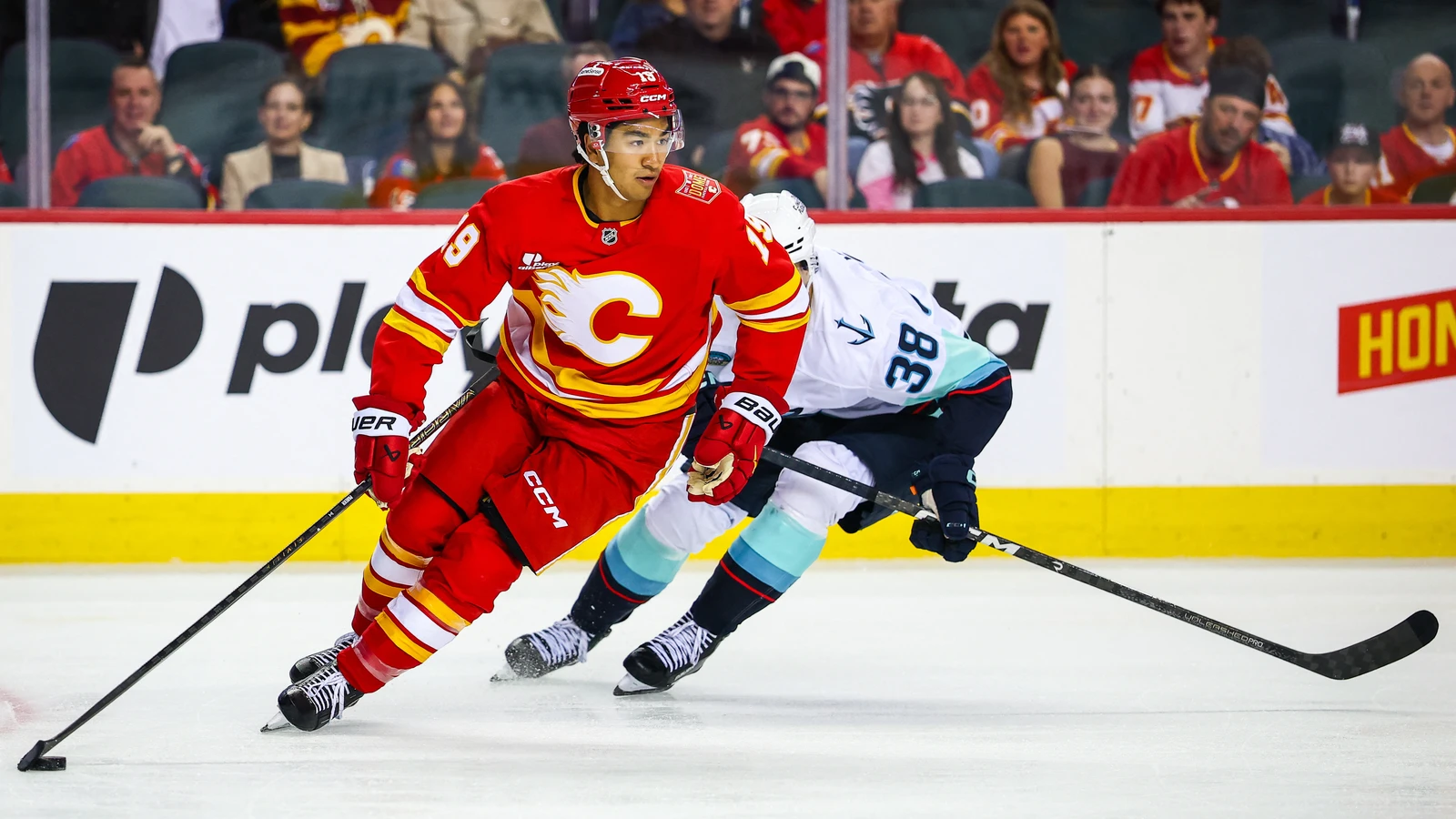 File photo: Calgary Flames defenceman Zayne Parekh (19) controls the puck against the Seattle Kraken at Scotiabank Saddledome on Sept. 20, 2026.