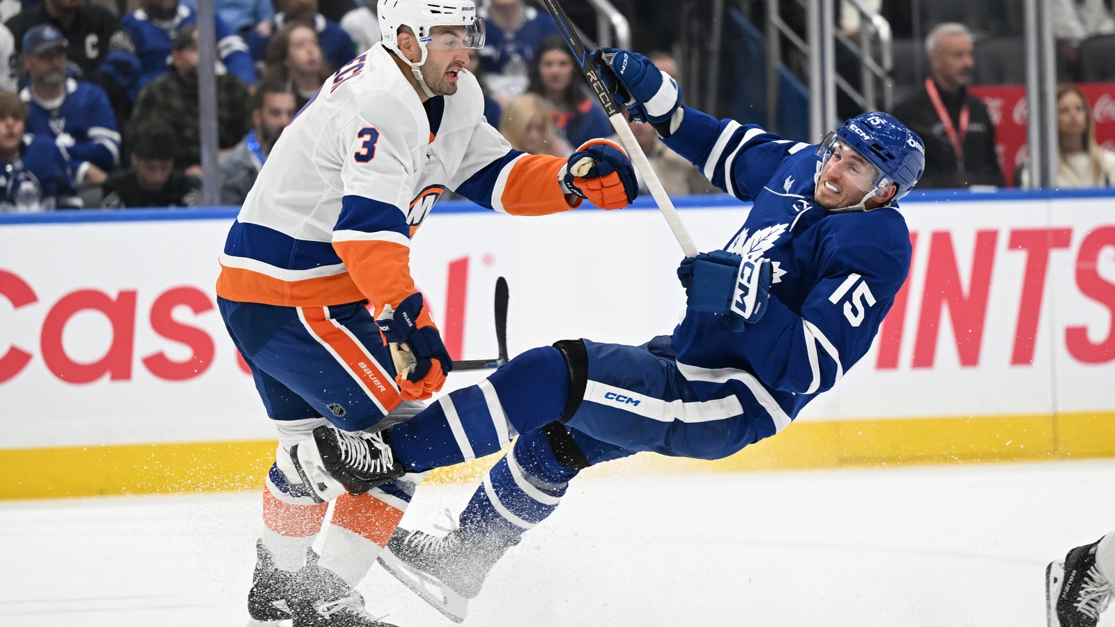File photo: New York Islanders defenceman Adam Pelech checks Toronto Maple Leafs forward Colton Sissons at Scotiabank Arena.