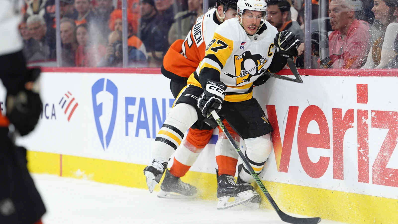 Sidney Crosby reaches for the puck for Pittsburgh during an April 2026 playoff game. File photo.
