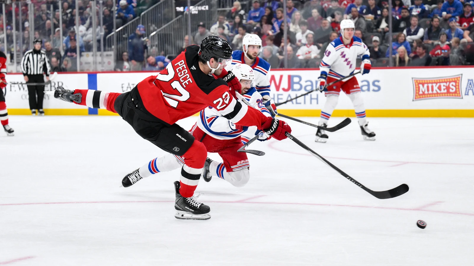 File photo: New Jersey Devils defenceman Brett Pesce takes a shot as a New York Rangers player defends at Prudential Center.