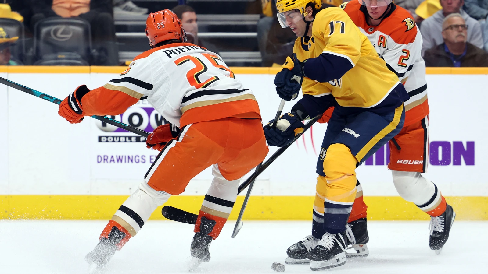 File photo: Tyson Jost of the Nashville Predators battles two Anaheim Ducks players for the puck in Nashville on April 16, 2026.