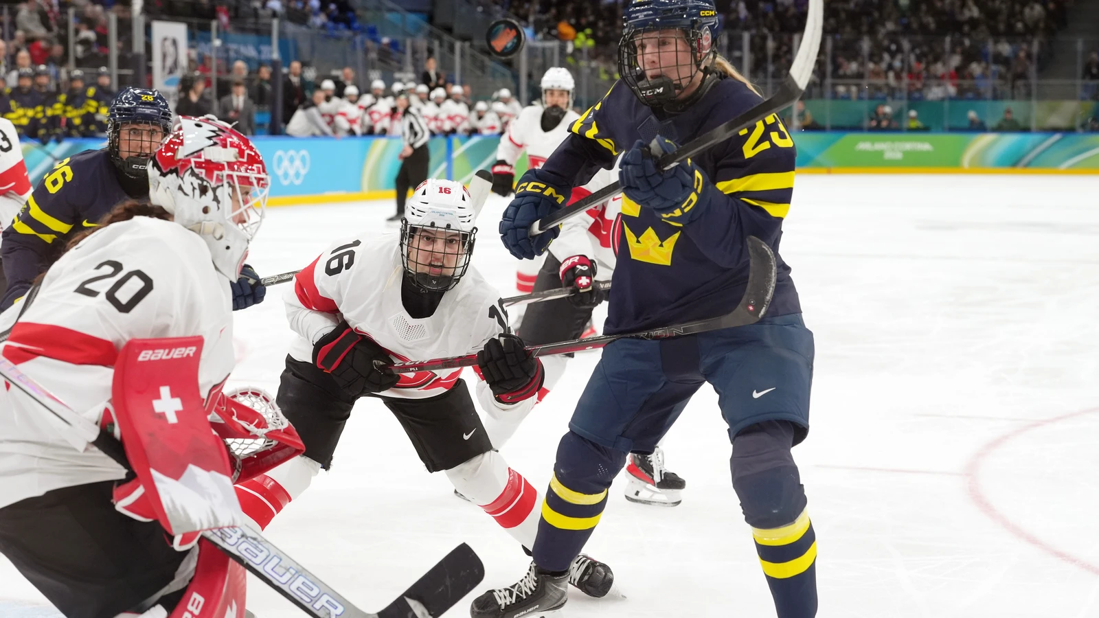 Sweden forward Thea Johansson battles Switzerland players near the net during the 2026 Olympic women’s hockey bronze-medal game in Milan. File photo.