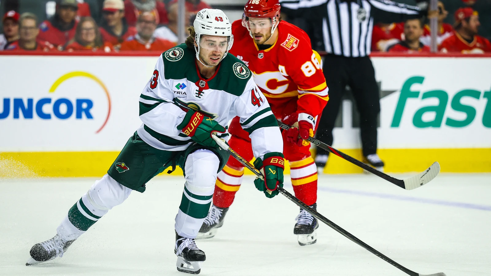 File photo: Minnesota Wild defenceman Quinn Hughes controls the puck against the Calgary Flames at Scotiabank Saddledome.