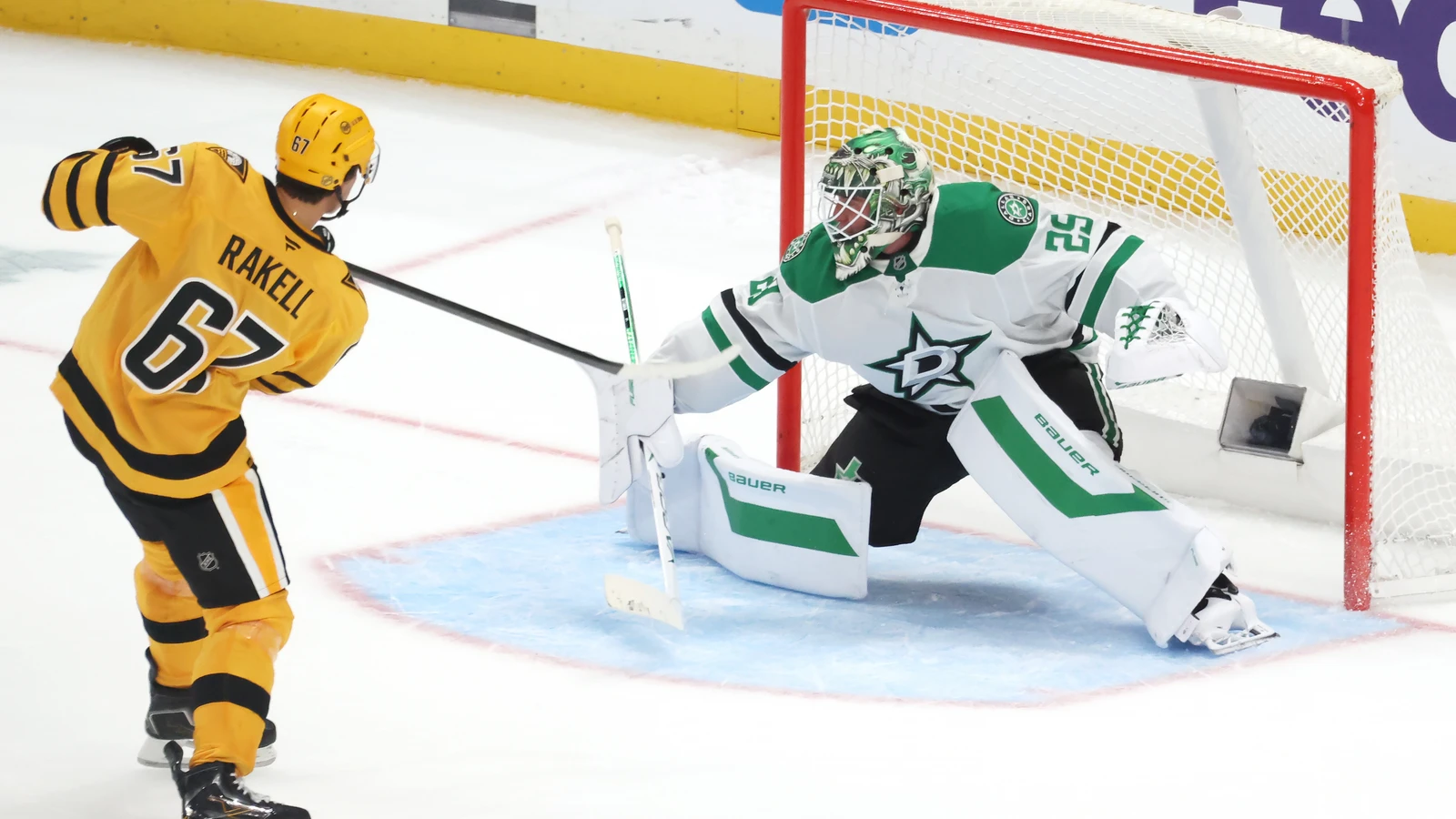 Pittsburgh Penguins winger Rickard Rakell shoots past Dallas Stars goaltender Jake Oettinger in the shootout.
