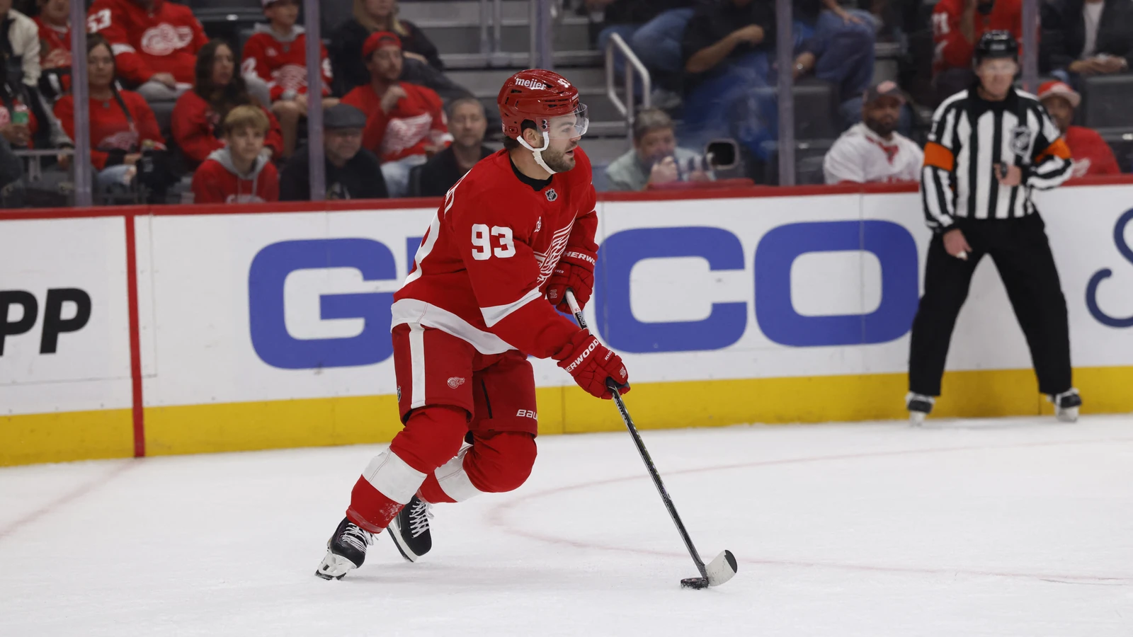 File photo: Red Wings forward Alex DeBrincat skates with the puck against the Rangers at Little Caesars Arena.