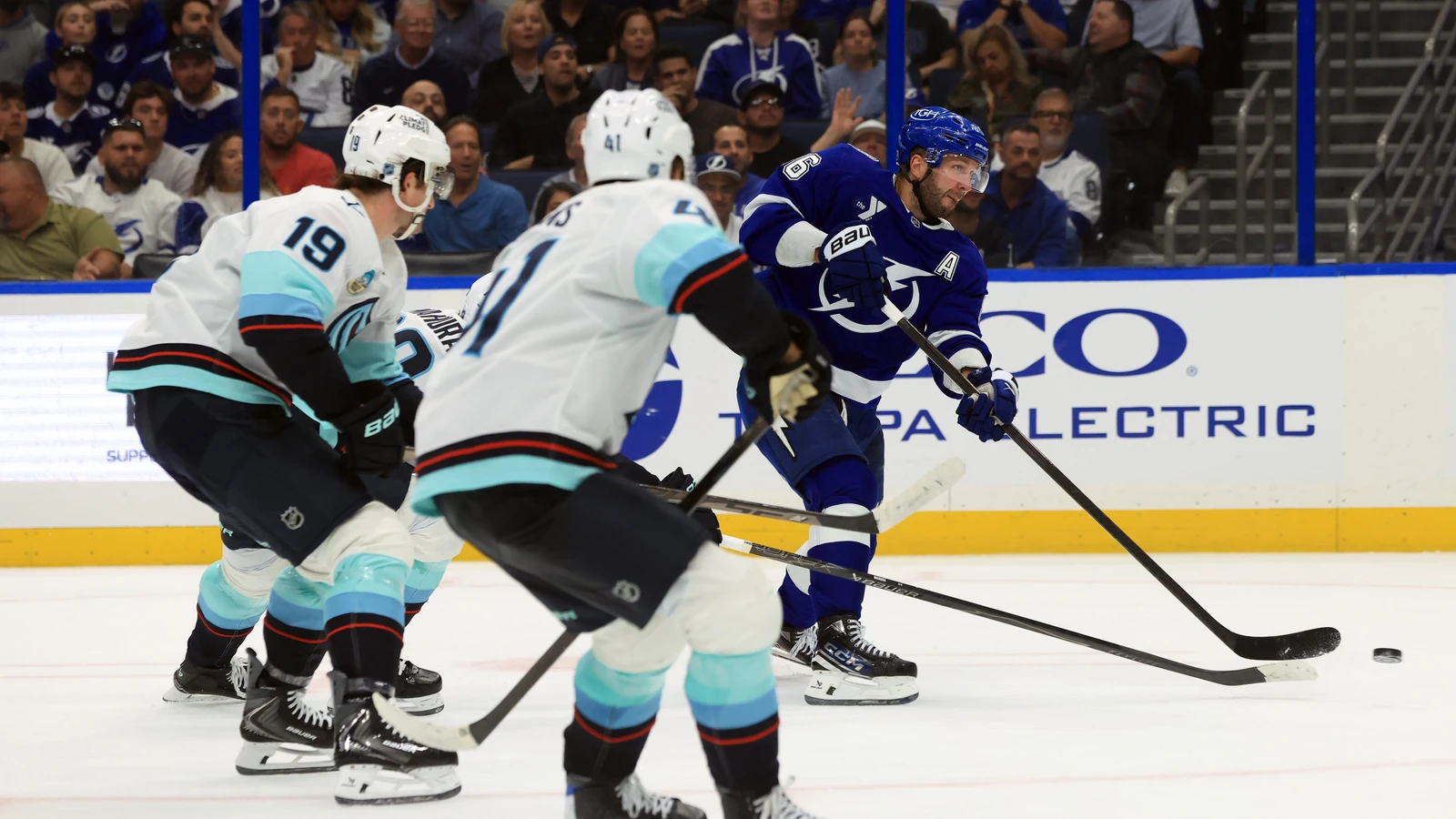 File photo: Tampa Bay Lightning forward Nikita Kucherov shoots as Seattle Kraken defenders close in.
