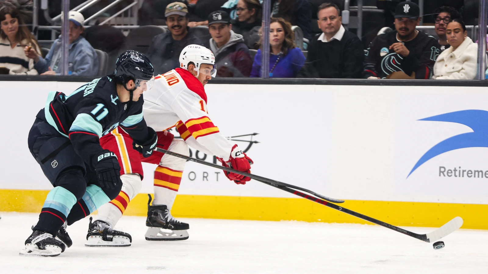 Mackie Samoskevich battles for the puck during the second period against Calgary at Climate Pledge Arena.