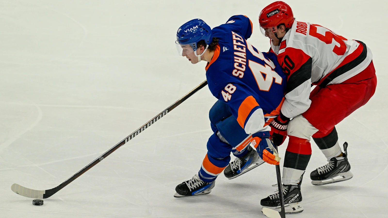 File photo: New York Islanders defenceman Matthew Schaefer, No. 48, controls the puck while Carolina Hurricanes forward Eric Robinson defends in Elmont on April 14, 2026.