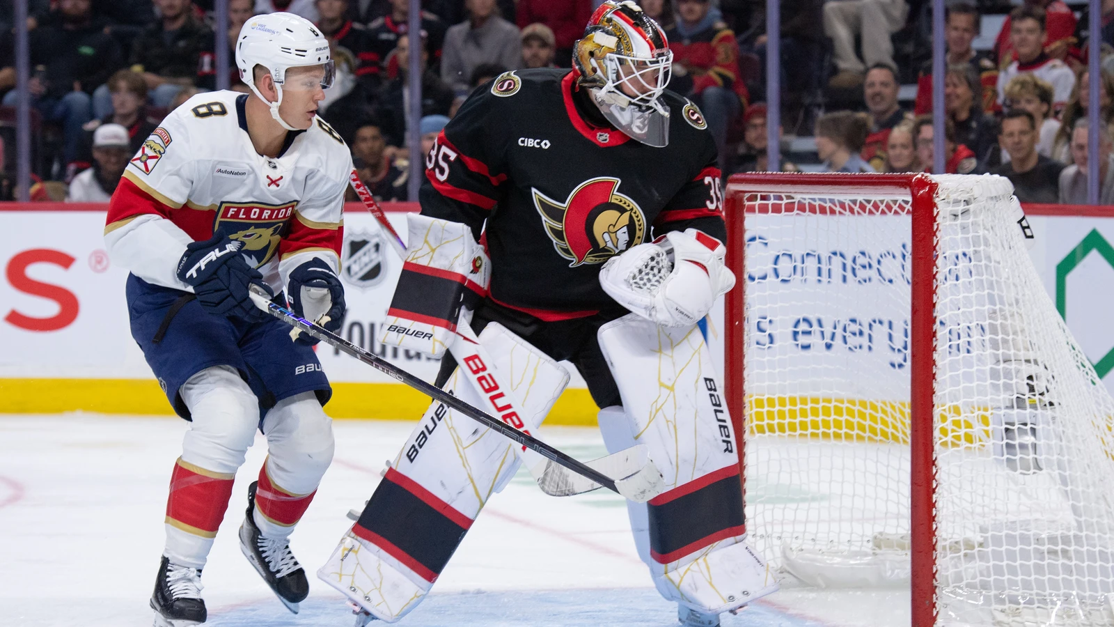 Ottawa Senators goalie Linus Ullmark and Florida Panthers forward Brady Tkachuk follow the puck beside the net at Canadian Tire Centre.